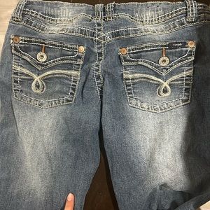 Low rise jeans. Used. Great condition. Designs on the back pockets.